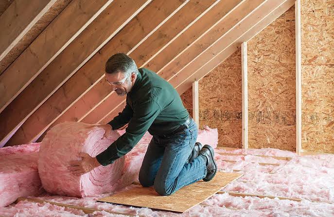 Attic insulation installed beneath a newly replaced roof deck