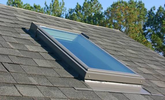 A VELUX deck-mounted skylight installed in a new shingle roof
